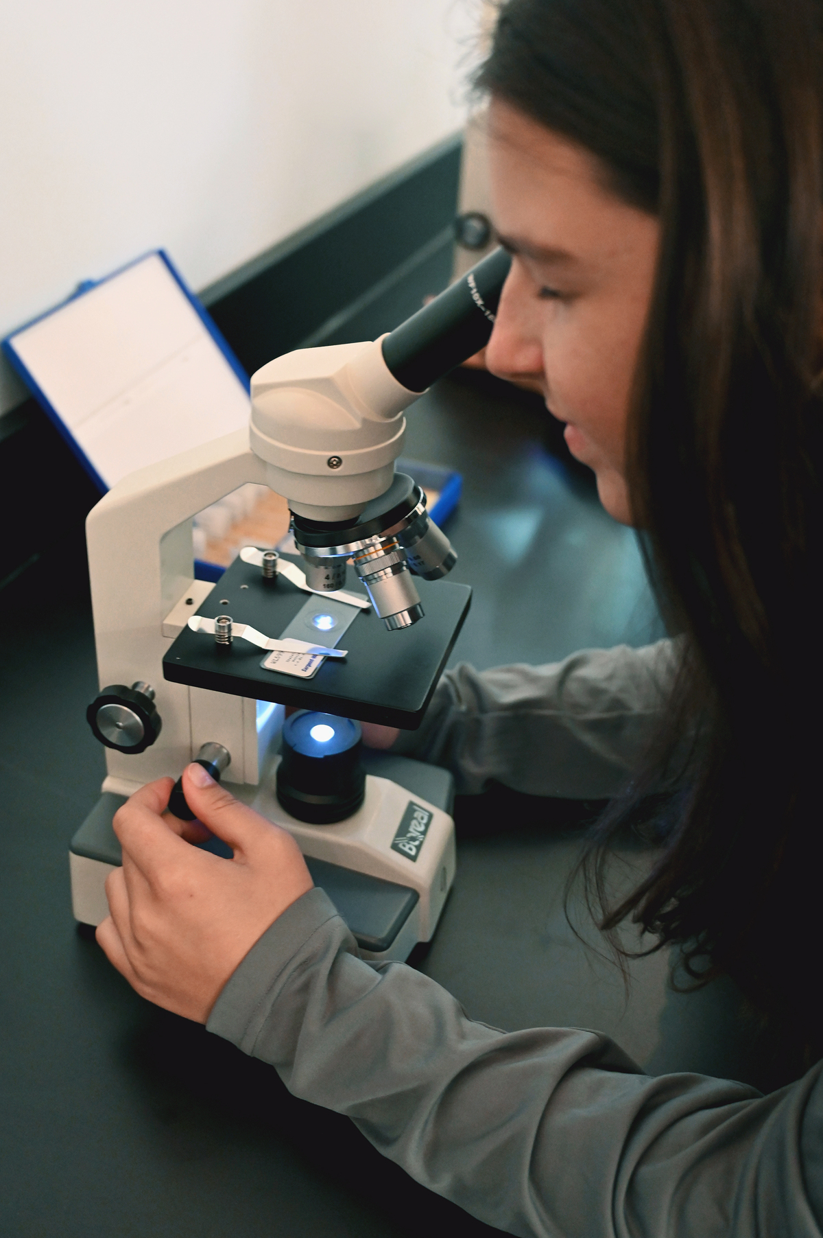 student with microscope